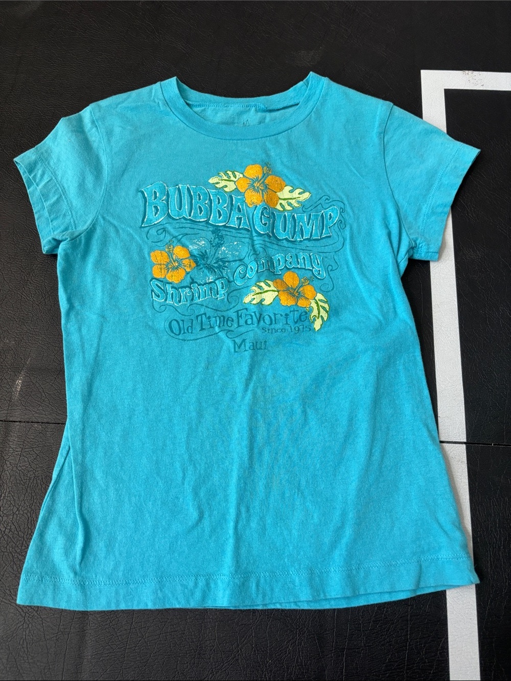 Bubba Gump Turquoise Short Sleeve Graphic Tee with Yellow Floral Accents